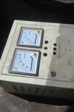 An industrial electrical control box featuring dual analog Stock Photos