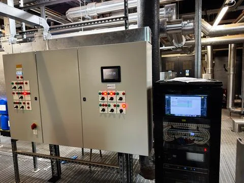 Industrial electrical control panel and server rack in mechanical plant roo.. Stock Photos