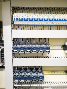 Industrial electrical control panel with wiring and circuit breakers Stock Photos