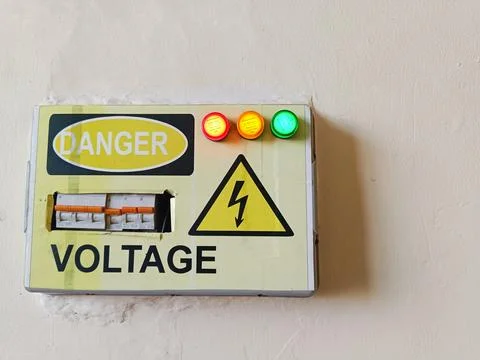 Industrial electrical distribution panel with high voltage warning sign. Stock Photos
