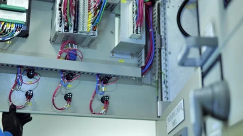 Industrial electrical engineer checking switchgear and control equipment in a mo 스톡 동영상 347143943