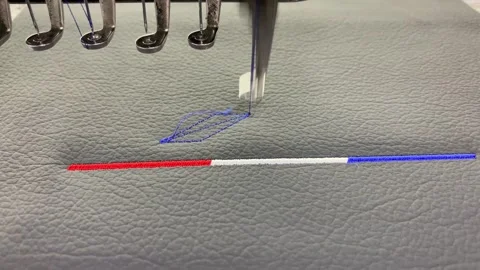 Industrial embroidery machine stitching above on textured synthetic leather Stock Footage 346812891