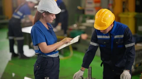 Industrial Engineer and Technician Inspecting Machinery in Manufacturing Plant Stock Footage 343428895