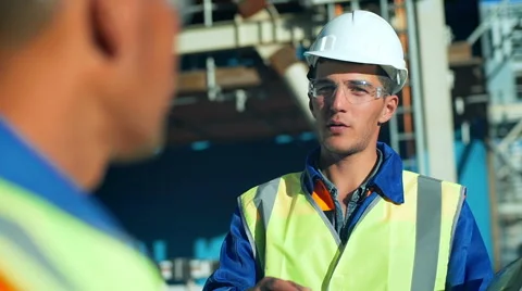 Industrial engineer and worker discussing in factory. Close-up Stock Footage 66906177