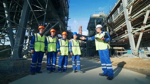 Industrial engineer and workers discussing in factory Stockbeeldmateriaal 66906143