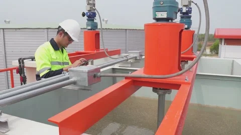 A industrial engineer controlling systems and inspecting water systems. Video stock 238432829
