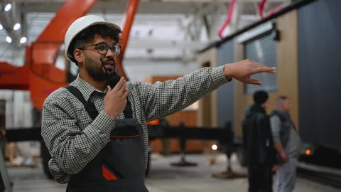 Industrial engineer explaining and giving instructions with walkie talkie Stock Footage 313084299
