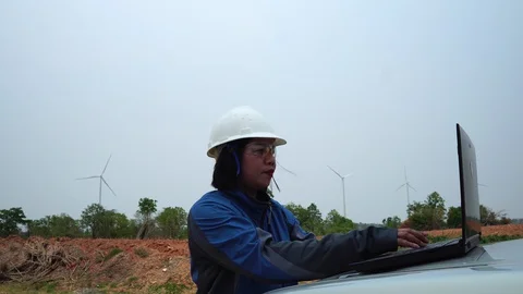 Industrial engineer in hard hat wearing wafety jacket uses touchscreen tablet  Stock Footage 127922058