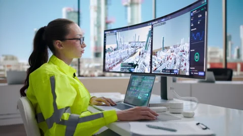 Industrial Engineer Monitors Real-time SCADA System Using Laptop Stock Footage 344712998
