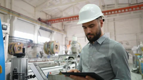 Industrial engineer operating machinery with digital tablet in pvc window Stock Footage 314580666