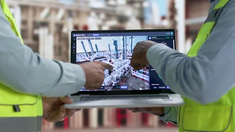 Industrial Engineer Reviews Real-time SCADA Data On Laptop Stock Footage 345313115