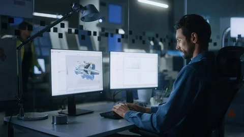 Industrial Engineer Solving Problems, Working on a PC, Monitor Show CAD Software Stock Footage 125480399