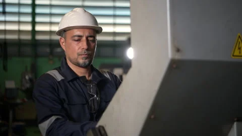 An industrial engineer stands in front of a control panel Stock Footage 339086665