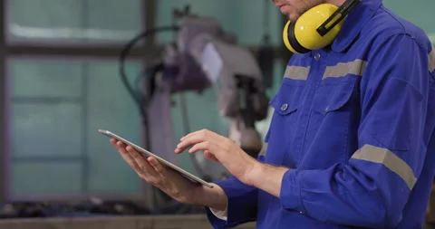 Industrial engineer using tablet check and control automation robot arms machine Stock Footage 152913890