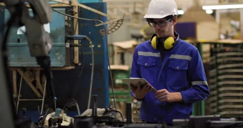 Industrial engineer using tablet check and control automation robot arms machine Video stock 199363162