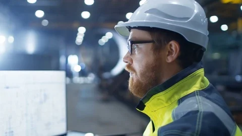  Industrial Engineer Wearing Hard Hat,  Safety Jacket and Glasses Smiles. Stock Footage