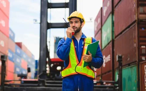 Industrial engineer worker working at overseas shipping container yard Stock Photos