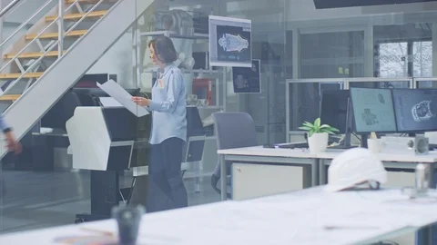 In Industrial Engineering Facility: Female Architect Prints Drafts of Engine Video stock 107782997