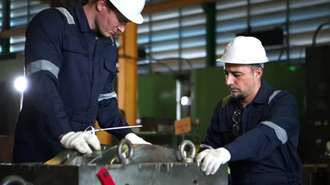 Industrial engineers and technicians discussing machine operation Stock Footage 339079326