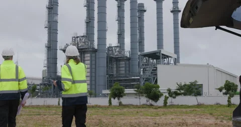 Industrial Engineers Discussing Construction Plans At Power Plant Facility .. Stock Footage 336537520