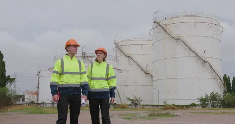 Industrial Engineers Discussing Infrastructure Project At Chemical Storage .. Stock Footage 335869744
