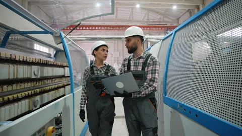 Industrial engineers discussing production process with laptop Video stock 314584198
