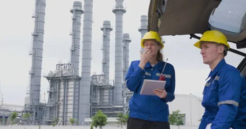 Industrial Engineers Discussing Technical Blueprints At Refinery Facility M.. Stock Footage 336537065