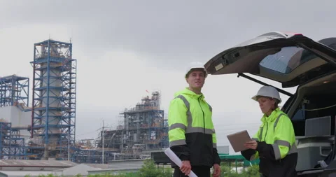Industrial Engineers Reviewing Construction Plans At Manufacturing Site Med.. Stock Footage 335871339