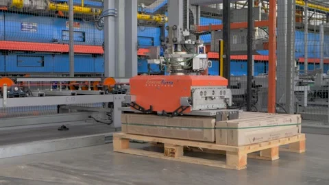 Industrial equipment aligning ceramic tiles on pallets in efficient assembly Video stock 314979717