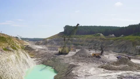 Industrial extraction of chalk in a large open pit. Quarry and mining equipment Stock Footage 136679037