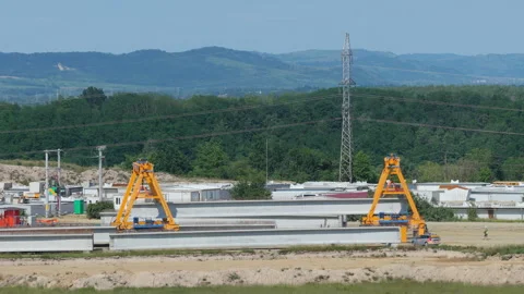 Industrial Fabrication Yard Where Two Giant Yellow Gantry Cranes Transport .. Stock Footage 338186022