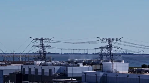 Industrial Facility and Power Lines by Water with Wind Turbines, Eemshaven Stock Footage 344428969