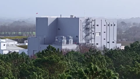 Industrial Facility Beyond Dense Forest Canopy Aerial Stock-Footage 333319434