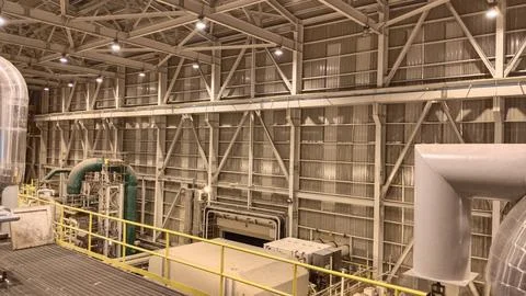 Industrial Facility Interior with Structural Framework and Machinery Stock Photos