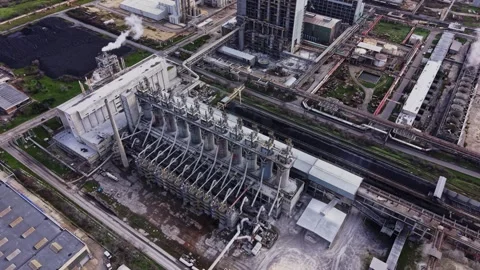 Industrial facility with large structures and machinery in operation Stock Footage 336546921