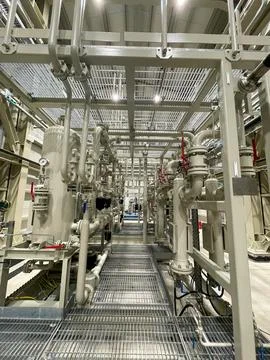 An industrial facility showcasing a complex system of metal pipes Stock Photos