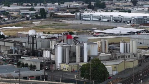 Industrial facility with silos, water tower and processing equipment beside Video stock 336504229
