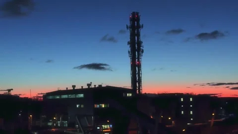 Industrial Facility with Smokestack Under a Dramatic sunrise Sky Stock Footage 297676604