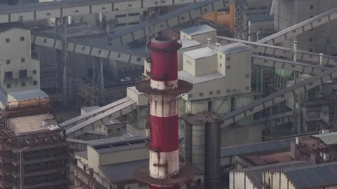 Industrial factory complex with red and white smokestack 스톡 동영상 329620799