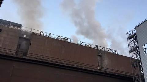 Industrial factory smokestacks belting out smoke and steam,in time lapse Stock Footage