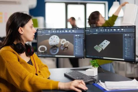 Industrial female engineer using on computer showing CAD software Fotos Stock