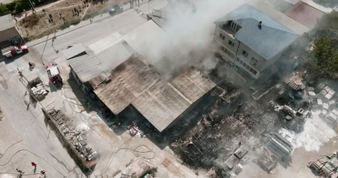 Industrial fire aftermath Firefighters work Stock Footage 303309566