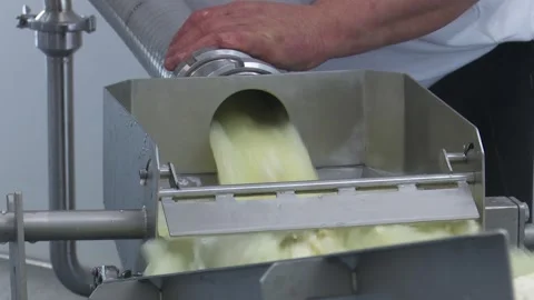 Industrial food processing: ingredient being poured into machinery a worker's 스톡 동영상 337060770
