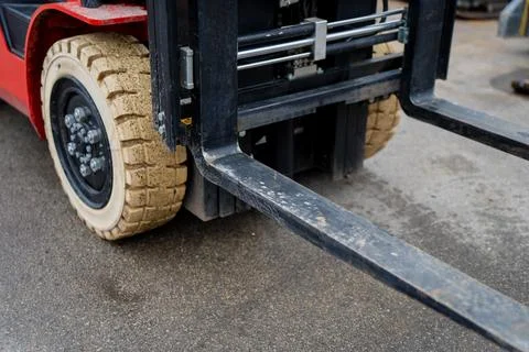 Industrial forklift with worn solid beige tires Stock Photos