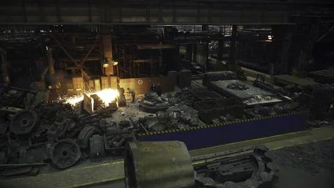 The Industrial Foundry Process includes the intricate flow of molten metal Stock Photos