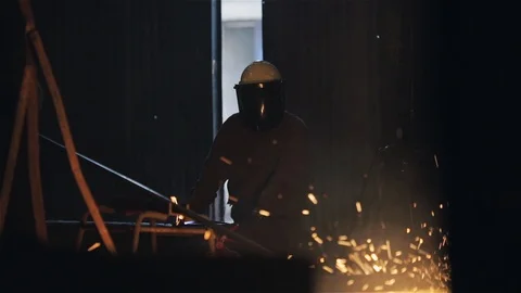 Industrial Foundry Worker Using Thermal Lance, Molten Metal Sparks, Argentina Stock Footage 90364861