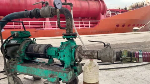 Industrial Fuel Transfer Pump Operating at Dockside with Large Oil Tanker Video stock 305037908