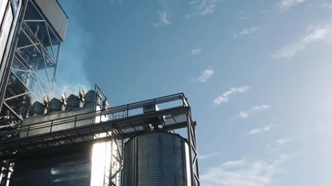 Industrial grain facility with silos and steam. Stock Footage 320115799