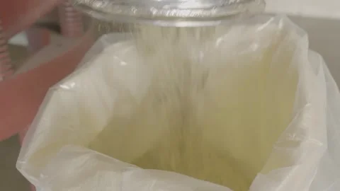 Industrial grain processing machine pouring seeds into a bag. Stock-Footage 330154816
