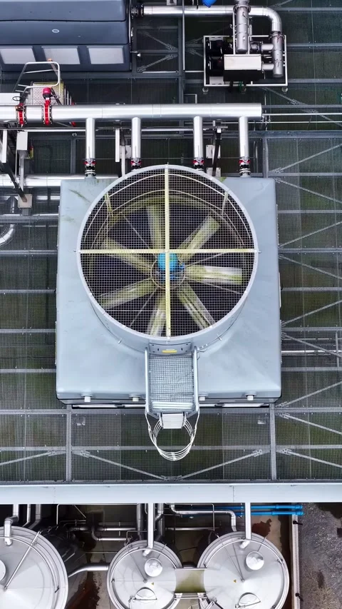 Industrial HVAC cooling system with large ventilation fans on a factory roof Stock Footage 336240847